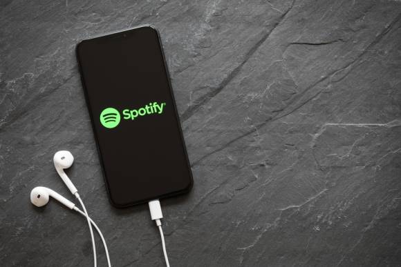 Smartphone mit kopfhörern und Spotify-App 